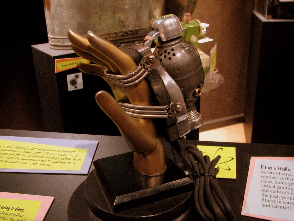 A bronze sculpted hand on display at a table