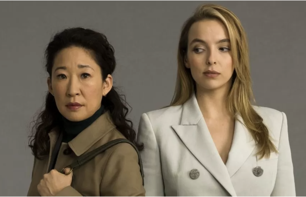 two women --the protagonists of the show -- look directly into the camera