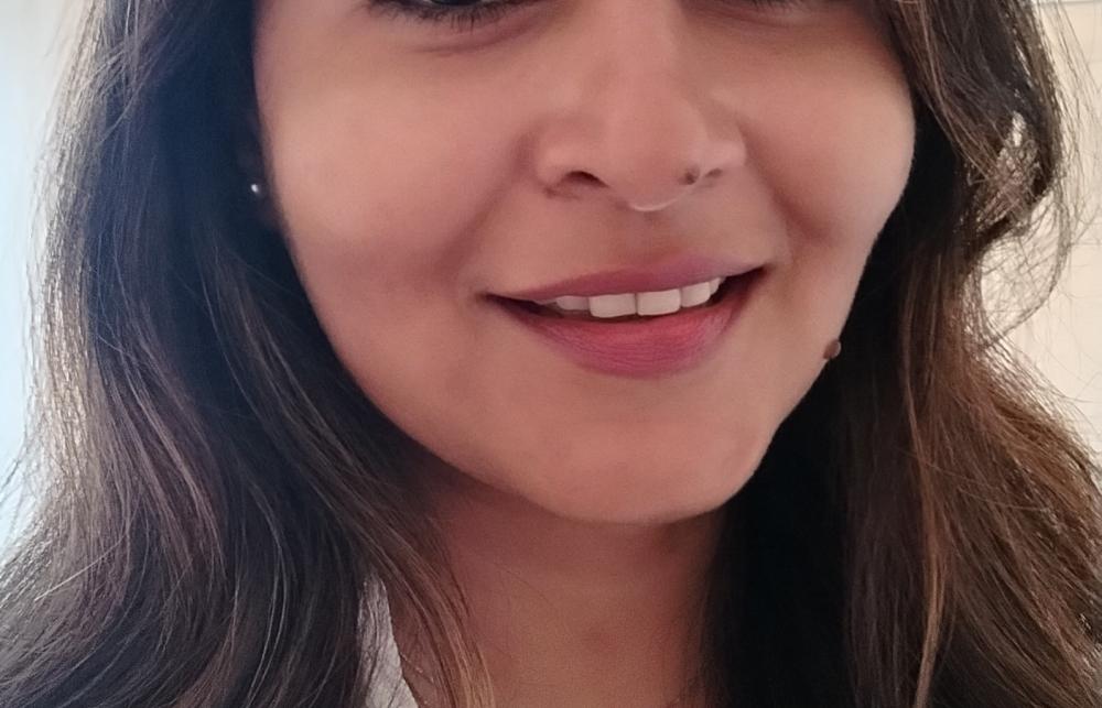 woman with long black hair and a smile