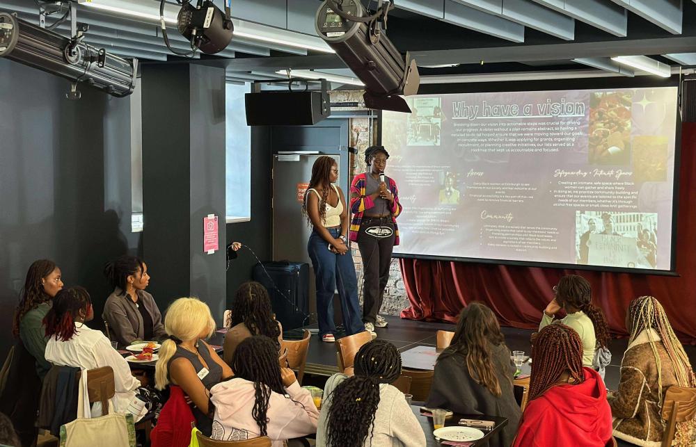 Rutendo and Claudia, President and Vice President of Black Women* at Edinburgh presenting at our first official event as a society in September 2024. Image credit: Katherina Alawode (2024)