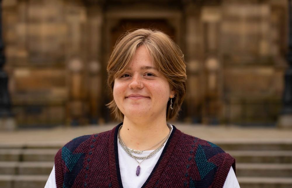 Portrait photo of Ash Scholz in front of McEwan Hall.