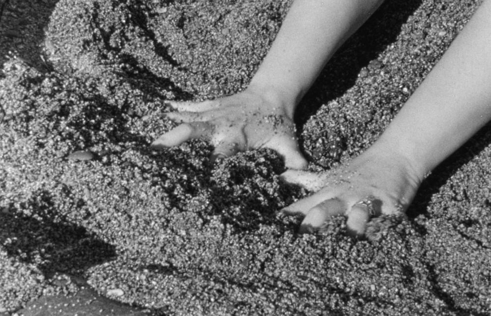 hands exploring sand