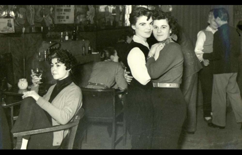 Black and white photograph of two women embracing at a club in the 1950s